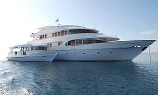 The Maldive liveaboard MV Carpe Diem with attending dhoni