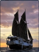 SMY Ondina sailing into the Komodo setting sun - photo courtesy of Adriano Morettin